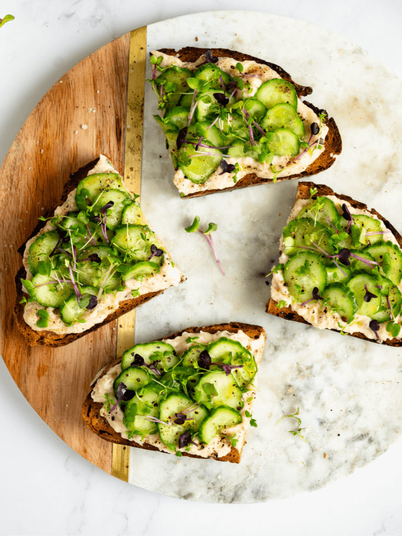 Toasted bread with mashed beans, cucumber and micro greens