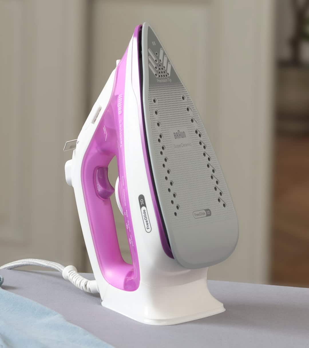 A pink Braun TexStyle 5 Steam iron in upright position